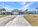 Charming one-story home with a curving driveway, front lawn, and an attached garage at 428 Briarwood Rd, Venice, FL 34293