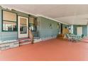 Spacious covered porch featuring outdoor seating, providing a comfortable and stylish area for relaxation and entertainment at 58 Lakeview Dr, North Port, FL 34287