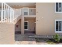 An exterior view of the condo building with stairs leading up to the second floor at 9850 Fiddlers Green Cir # 130, Rotonda West, FL 33947