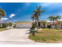 Inviting single-Gathering home with a well-manicured lawn, mature trees, and a convenient two-car garage at 1134 Coronado Dr, Punta Gorda, FL 33950