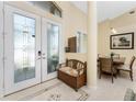 Warm and inviting foyer with tile flooring, a decorative bench, and a view of the dining area at 1134 Coronado Dr, Punta Gorda, FL 33950