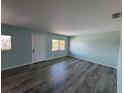 Spacious living room featuring wood floors and large windows providing ample natural light at 1258 Barbara Dr # 202, Venice, FL 34285