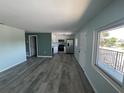 Open living space with wood flooring, bright lighting, and stainless steel appliances at 1258 Barbara Dr # 202, Venice, FL 34285