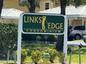 Links Edge Condominium sign shows the well-maintained landscaping and proximity to residential parking at 1295 Saxony Cir # 2101, Punta Gorda, FL 33983