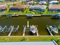 A personal boat is attached to the boat lift in the canal behind this property at 1318 Wesley Dr # 7, Punta Gorda, FL 33950
