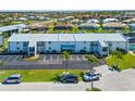 Well-maintained building exterior with ample parking and tropical landscaping at 1318 Wesley Dr # 7, Punta Gorda, FL 33950