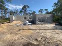 Image of block-built new construction, framed for windows and doors, on a sunny day at 135 Hardee Way, Rotonda West, FL 33947