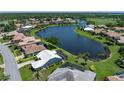 A stunning aerial view of a home with a beautiful lake view, highlighting its prime location and desirable setting at 13761 Long Lake Ln, Port Charlotte, FL 33953