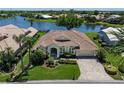 A scenic aerial shot showcases the home's lush landscaping and serene lake views, offering a private and tranquil setting at 13761 Long Lake Ln, Port Charlotte, FL 33953