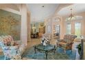 Inviting living room with a neutral color palette, large windows, and a view of the dining area at 13761 Long Lake Ln, Port Charlotte, FL 33953