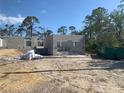 A home under construction shows the block walls and window openings on a sunny lot with scattered trees at 139 Hardee Way, Rotonda West, FL 33947