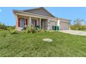 Charming single-story home with a well-maintained lawn, red shutters, and a front-facing two car garage at 15345 Pottstown Ave, Port Charlotte, FL 33981