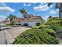 Beautiful home with a tile roof, lush landscaping, brick driveway and three-car garage at 196 Tarpon Cove Blvd # 722, Punta Gorda, FL 33950