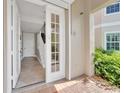 Inviting foyer with tiled floors, a staircase, an open front door, and lots of natural light at 196 Tarpon Cove Blvd # 722, Punta Gorda, FL 33950