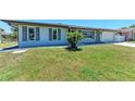 Well-kept single-story home boasts a manicured lawn and shuttered windows at 309 Aurora St, Port Charlotte, FL 33948