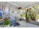 Relaxing enclosed porch with ceiling fan, charming décor, ample natural light, and seating area at 3305 Blue Jay Ln, Englewood, FL 34224