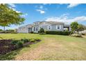 Inviting single-story home with manicured lawn and lush landscaping, showcasing curb appeal under a sunny sky at 3664 Tin Cup Blvd, Sarasota, FL 34232
