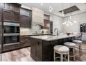 Gourmet kitchen with stainless steel appliances, large island, and modern light fixtures at 3729 Peace River Dr, Punta Gorda, FL 33983