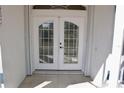 Double doors with decorative grids and modern door hardware provides privacy and security at 5050 Prosch Cir, North Port, FL 34288