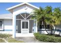This charming single Gathering home features a screened-in front porch, tropical landscaping and lots of curb appeal at 5050 Prosch Cir, North Port, FL 34288