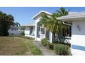 This single Gathering home is surrounded by mature landscaping that includes palms and shrubbery at 5050 Prosch Cir, North Port, FL 34288