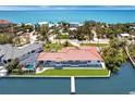 Stunning waterfront property featuring a private dock, lush landscaping, and an inviting pool area, perfect for relaxation and entertainment at 8115 Manasota Key Rd, Englewood, FL 34223