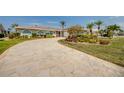 Beautiful driveway leads to a well-maintained home surrounded by tropical landscaping at 925 Don Juan Ct, Punta Gorda, FL 33950