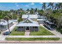 Attractive exterior view of a two-story home with a wrap-around porch and well-maintained landscaping at 110 Gilchrist St, Punta Gorda, FL 33950