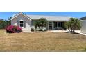 Charming home features an easy to maintain yard with lush landscaping and a mix of painted brick and siding at 18954 Ayrshire Cir, Port Charlotte, FL 33948
