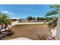 Beautiful home boasting a spacious front yard adorned with mature trees and a long driveway leading to the property at 18954 Ayrshire Cir, Port Charlotte, FL 33948
