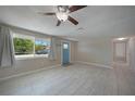 Bright living room featuring light tile flooring, neutral walls, and large window at 20215 Macon Ln, Port Charlotte, FL 33952