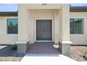 Inviting front entrance with a double door, brick paved landing, and decorative stone columns at 2186 Florala St, North Port, FL 34287