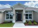 Inviting front entryway with decorative lighting and beautiful landscaping details at 23245 Jules Ave, Port Charlotte, FL 33980