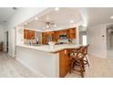 Bright kitchen with stainless steel appliances, a breakfast bar, and wood cabinets at 283 Fields Se Ter, Port Charlotte, FL 33952