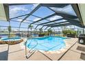 Screened-in pool and jacuzzi overlooking a canal, perfect for outdoor relaxation and entertainment at 283 Fields Se Ter, Port Charlotte, FL 33952