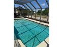 Inviting in-ground pool with a screened enclosure, perfect for outdoor relaxation at 376 Waterside St, Port Charlotte, FL 33954