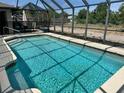 Private backyard pool with a screened-in lanai for outdoor enjoyment and relaxation at 376 Waterside St, Port Charlotte, FL 33954