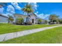 Well-maintained single-story home featuring a lush green lawn and tropical landscaping at 3866 Turtle Dove Blvd, Punta Gorda, FL 33950