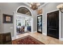 Elegant foyer with travertine floors, arched entry, and decorative glass door at 3866 Turtle Dove Blvd, Punta Gorda, FL 33950
