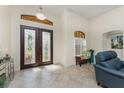 Elegant foyer featuring tile flooring, transom window, and a striking double-door entrance at 4015 La Costa Island Ct, Punta Gorda, FL 33950