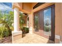 Inviting front porch with decorative tile flooring, and double doors with decorative glass inserts at 4015 La Costa Island Ct, Punta Gorda, FL 33950
