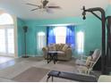 Bright living area with tiled floors, lots of natural light, and a ceiling fan at 4309 Badali Rd, North Port, FL 34286