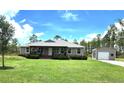 Inviting single-story home with a well-manicured lawn and a detached garage or shed on a sunny day at 6405 Alan Blvd, Punta Gorda, FL 33982