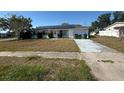 This home has solar panels, an attached garage and a grassy front yard at 8782 La Boca Ave, North Port, FL 34287