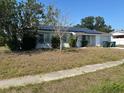 Charming single-story home with solar panels and manicured bushes in the front yard at 8782 La Boca Ave, North Port, FL 34287