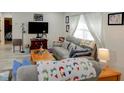 Bright living room featuring wood-look floors, comfortable gray sofas, a wood coffee table and natural light at 8795 56Th N St, Pinellas Park, FL 33782