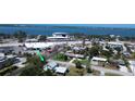 Aerial view showcasing a cozy white house near the water, businesses, and local amenities at 899 S Broadway, Englewood, FL 34223