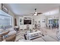 Open-concept living room with stylish decor, ample seating, and abundant natural light at 949 Springview Nw Ave, Port Charlotte, FL 33948