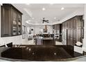 Gourmet kitchen with granite countertops, stainless steel appliances, and custom dark wood cabinetry at 10580 Poughkeepsie Cir, Port Charlotte, FL 33981