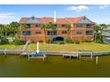 Condo rear view with manicured landscaping and docks for water access at 1326 Wesley Dr # 132, Punta Gorda, FL 33950